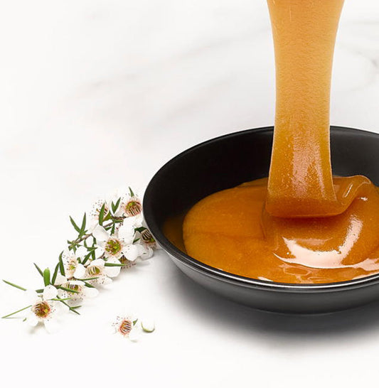 honey dripping into bowl