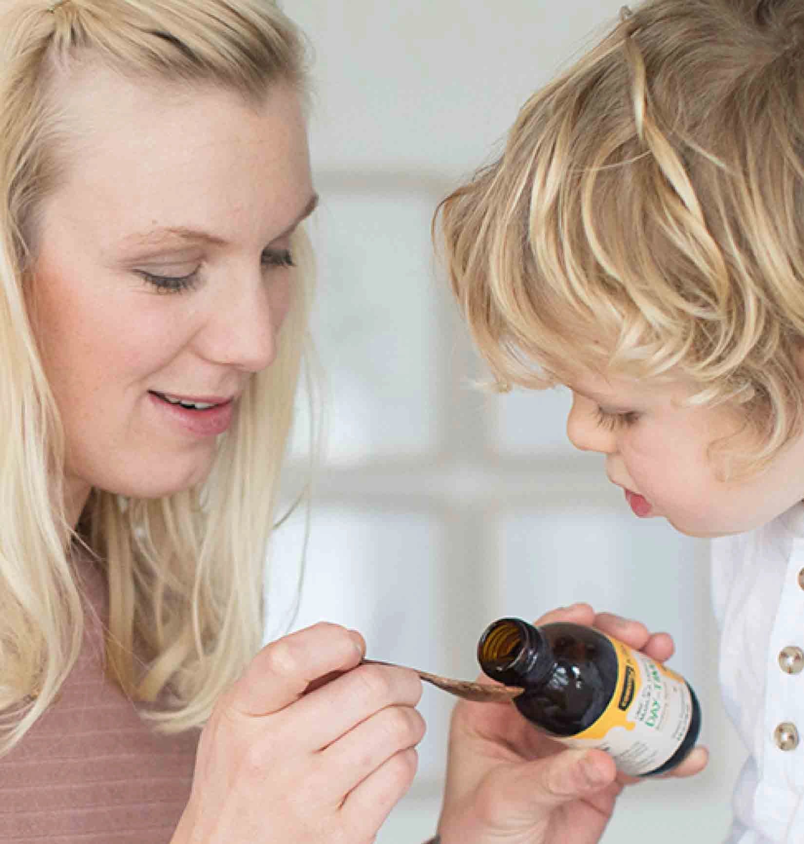 mum giving child soothing syrup