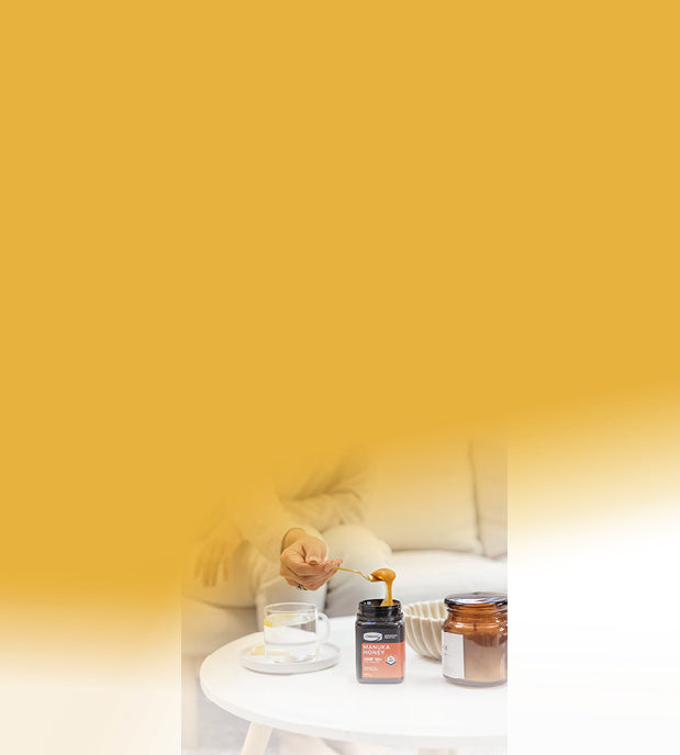 woman adding manuka honey to water