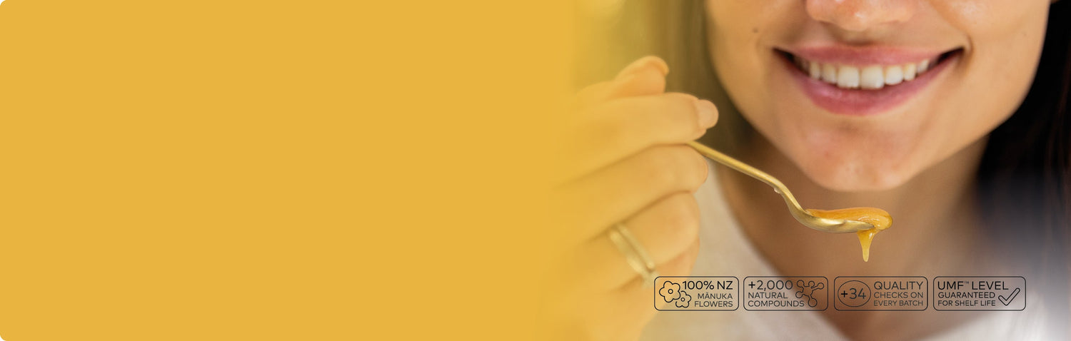 woman taking a spoonful of manuka honey