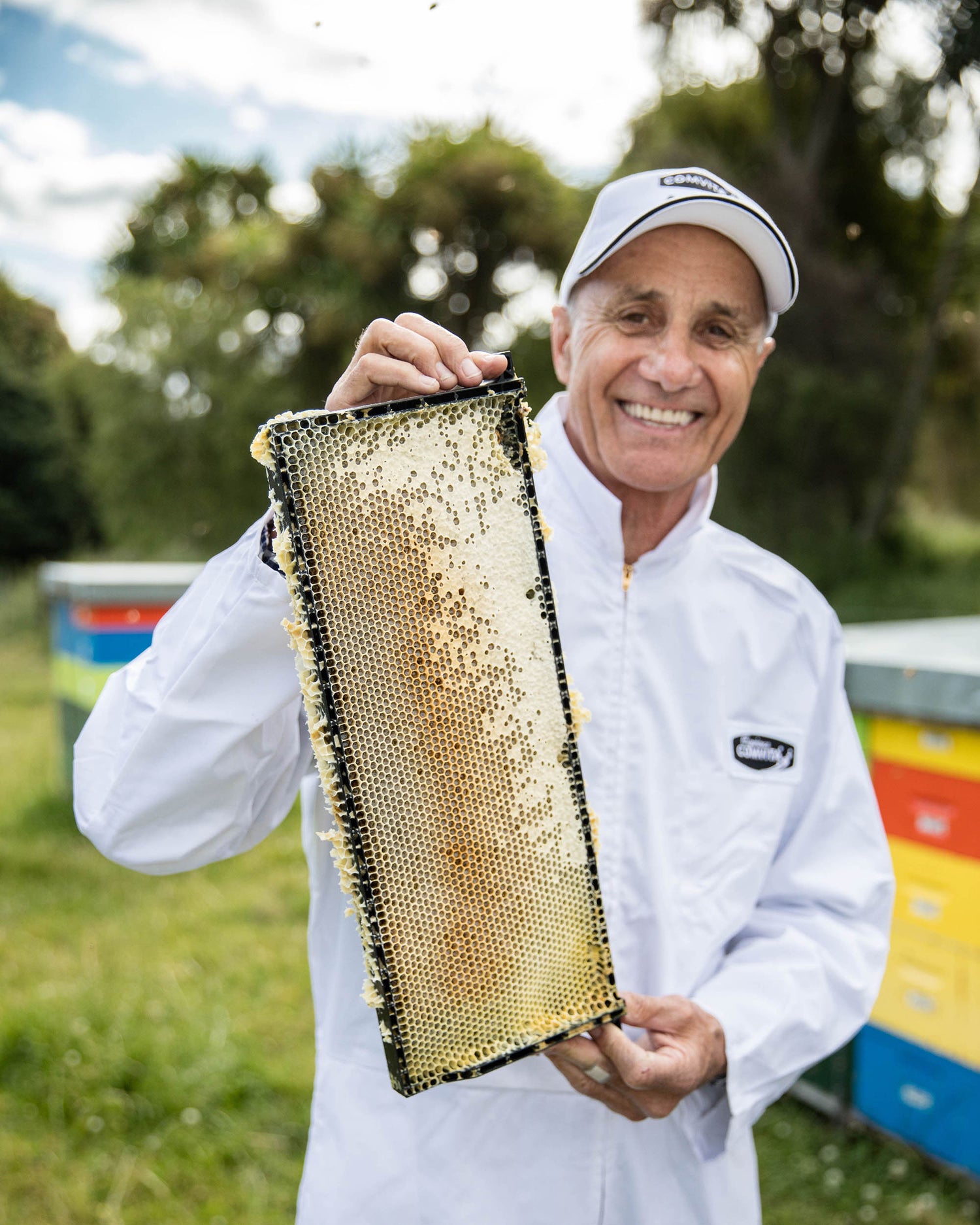 alan bougen with a hive frame filled with honey